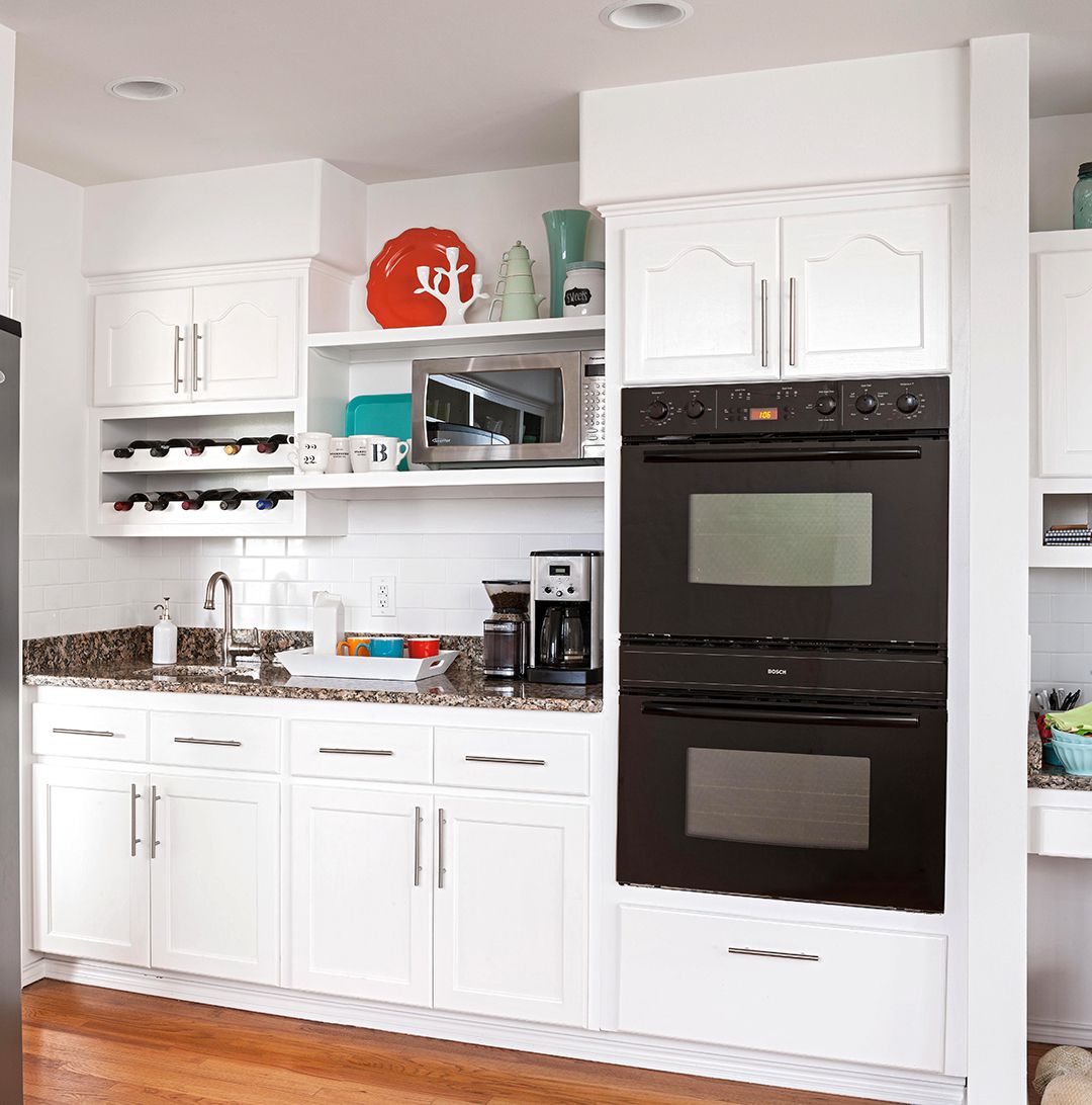 modern white kitchen with black appliances